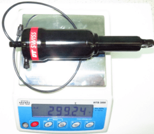 DT Swiss MRF rear shock absorber placed on a precision scale showing a weight of 299.24 grams