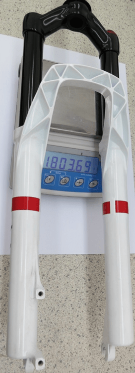 Lightweight MRF suspension fork placed on a precision scale, displaying a weight of 1803.69 grams